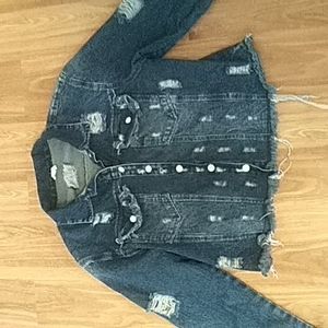 A a dark blue jean jacket with newspaper cover on the back